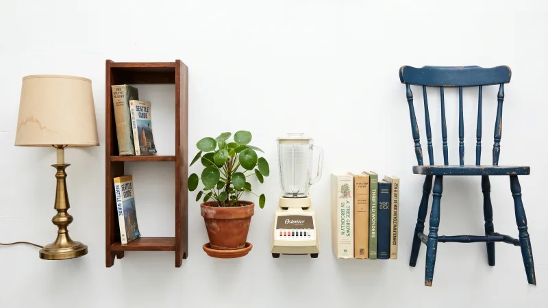 Moving boxes and furniture stacked by a city curb during a lease turnover